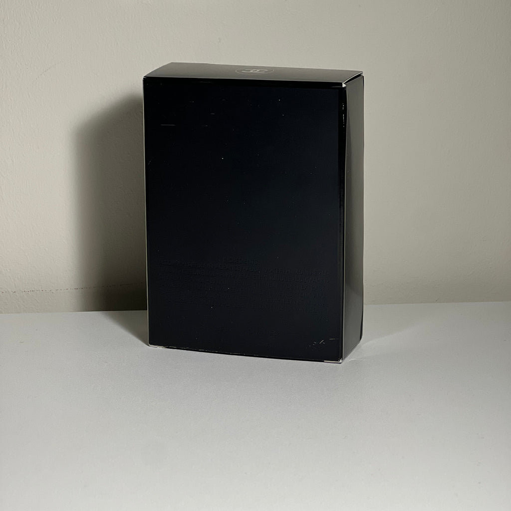 Black rectangular object on a light gray wall