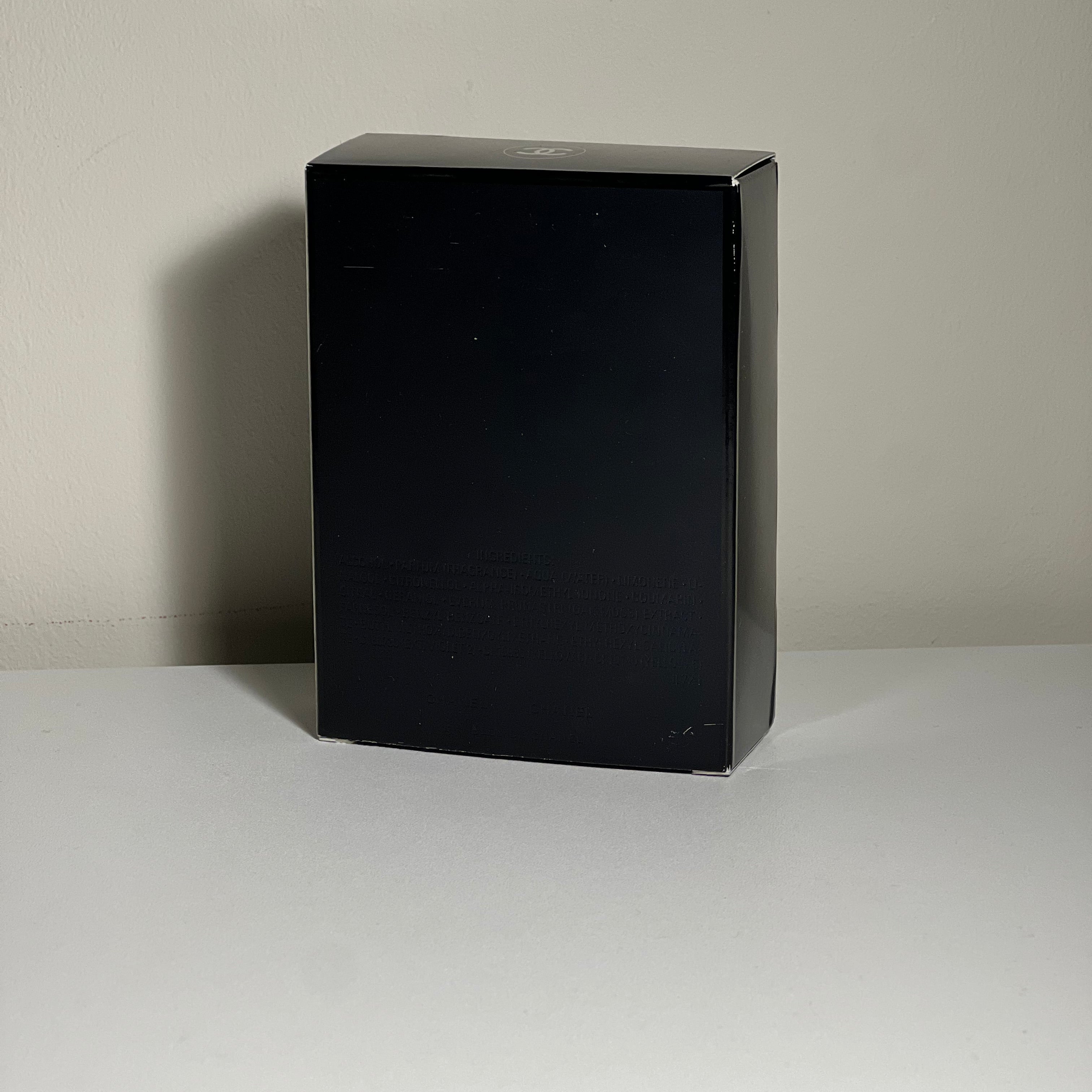 Black rectangular object on a light gray wall