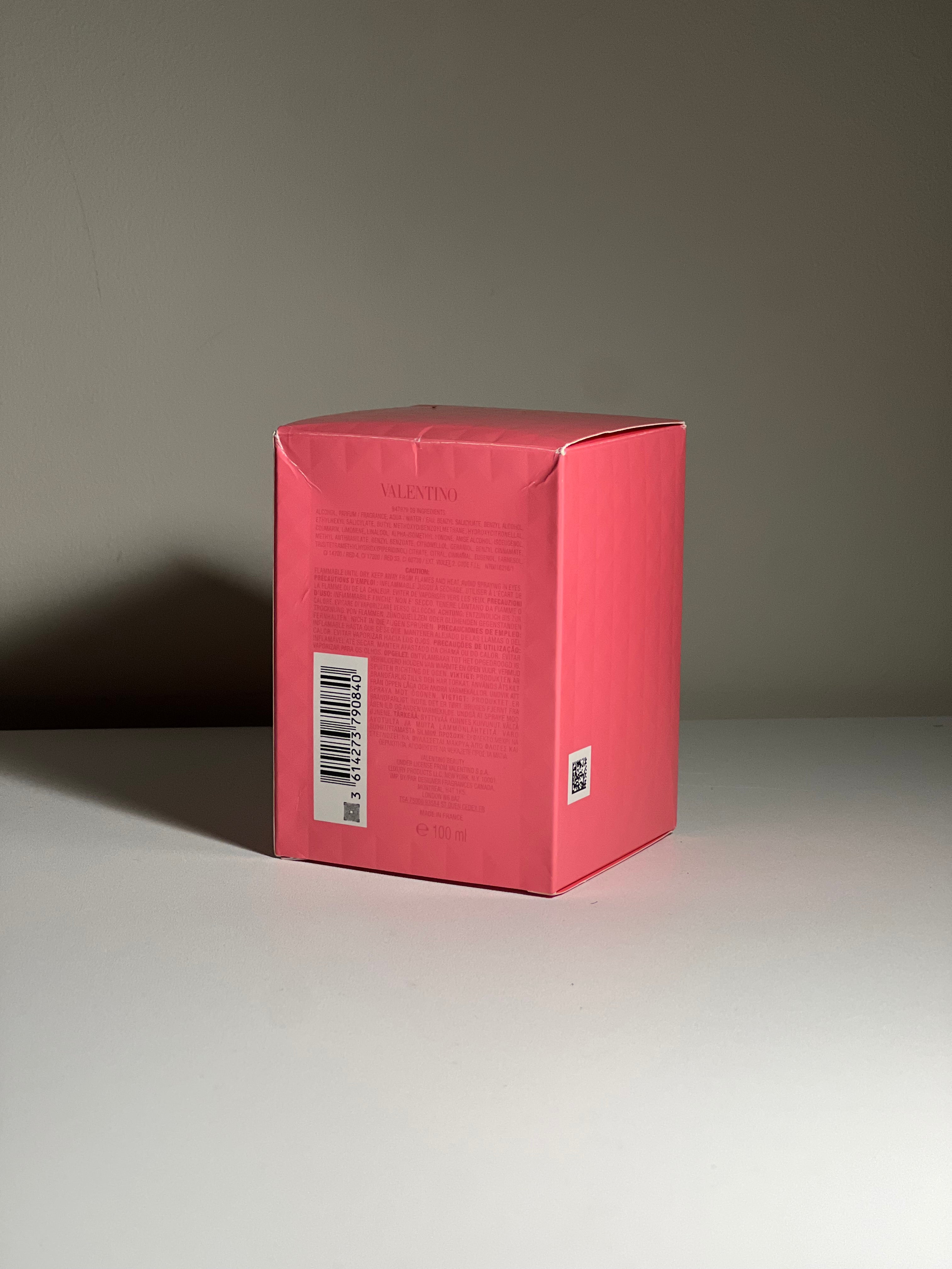 Red Valentino box with a barcode on a gray surface