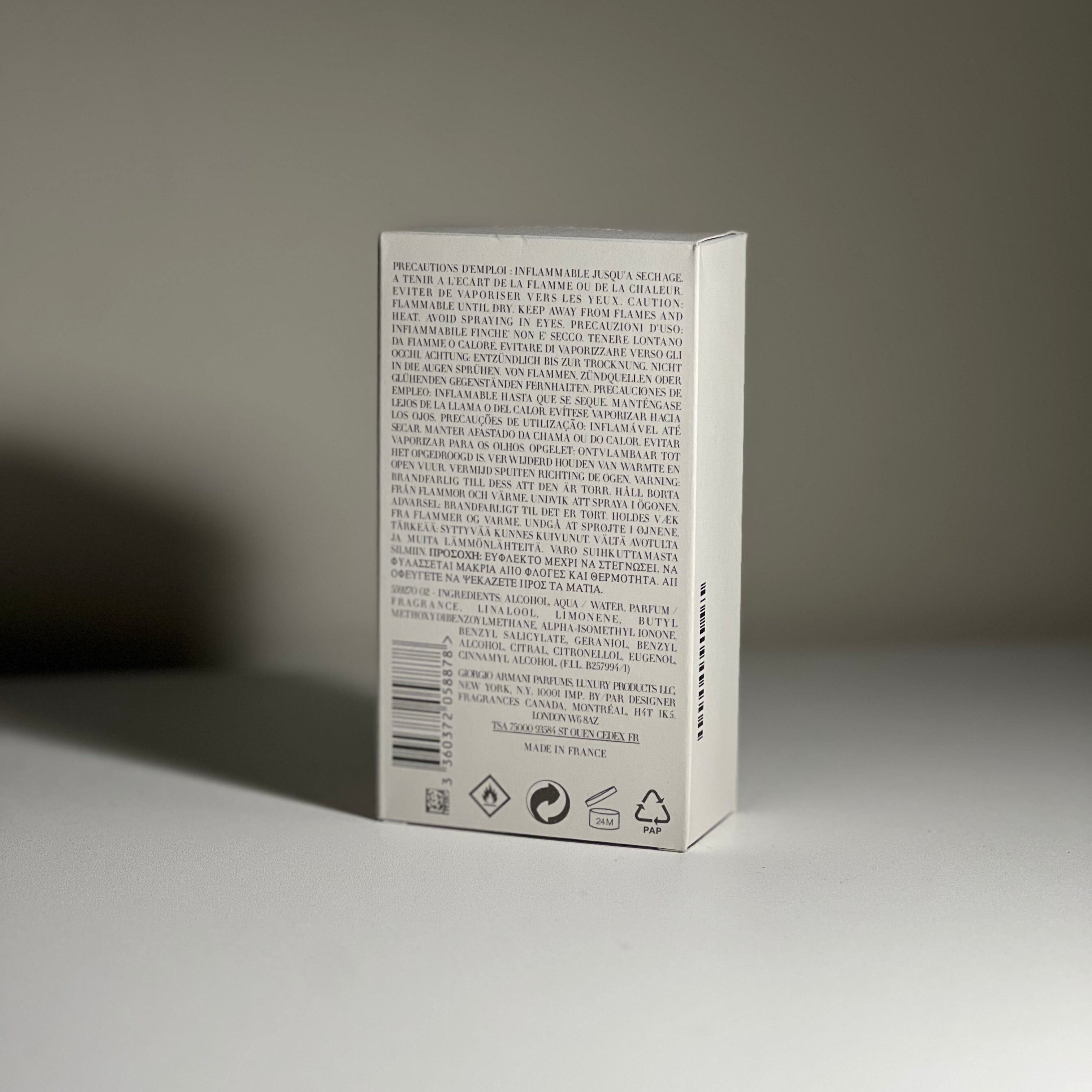 Acqua di gio packaging box with text and symbols on a gray background