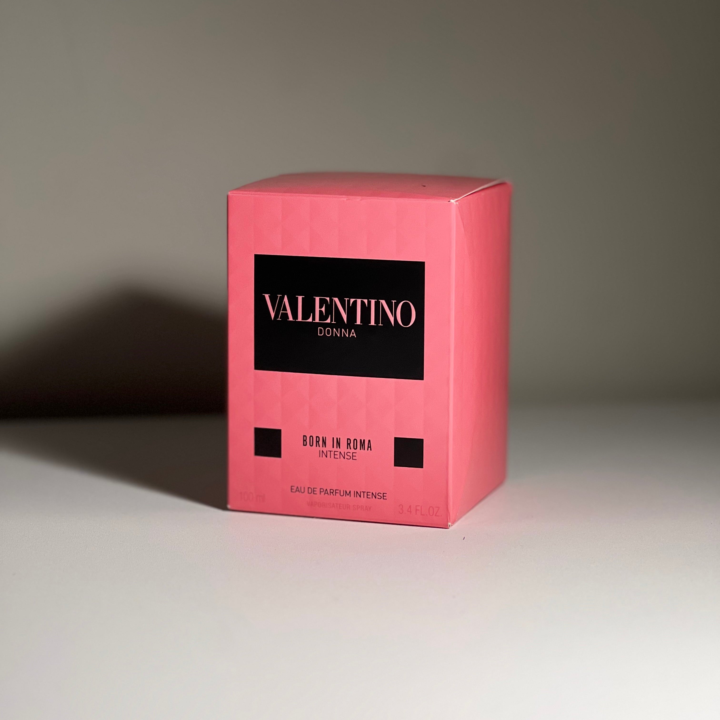 Pink Valentino perfume box on a gray background