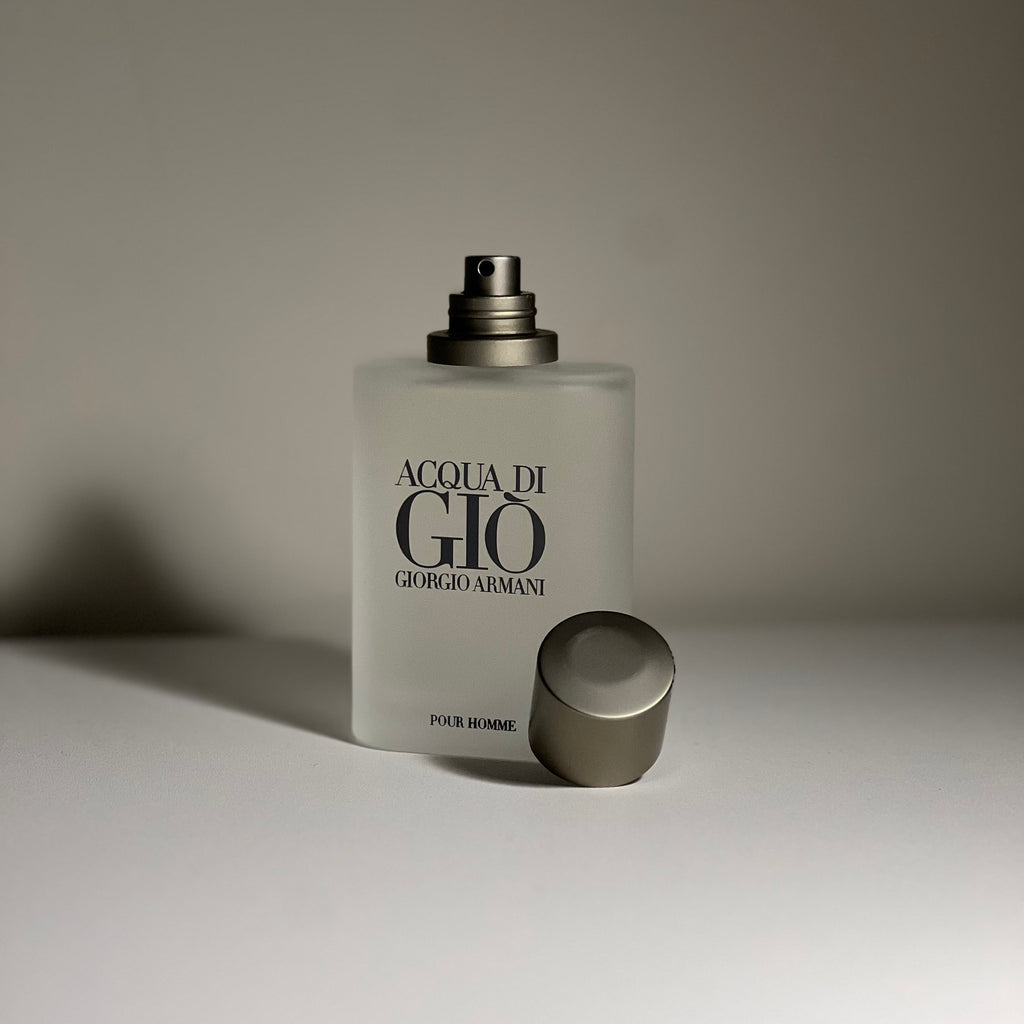 Perfume bottle labeled 'Acqua di Gio' by Giorgio Armani on a neutral background