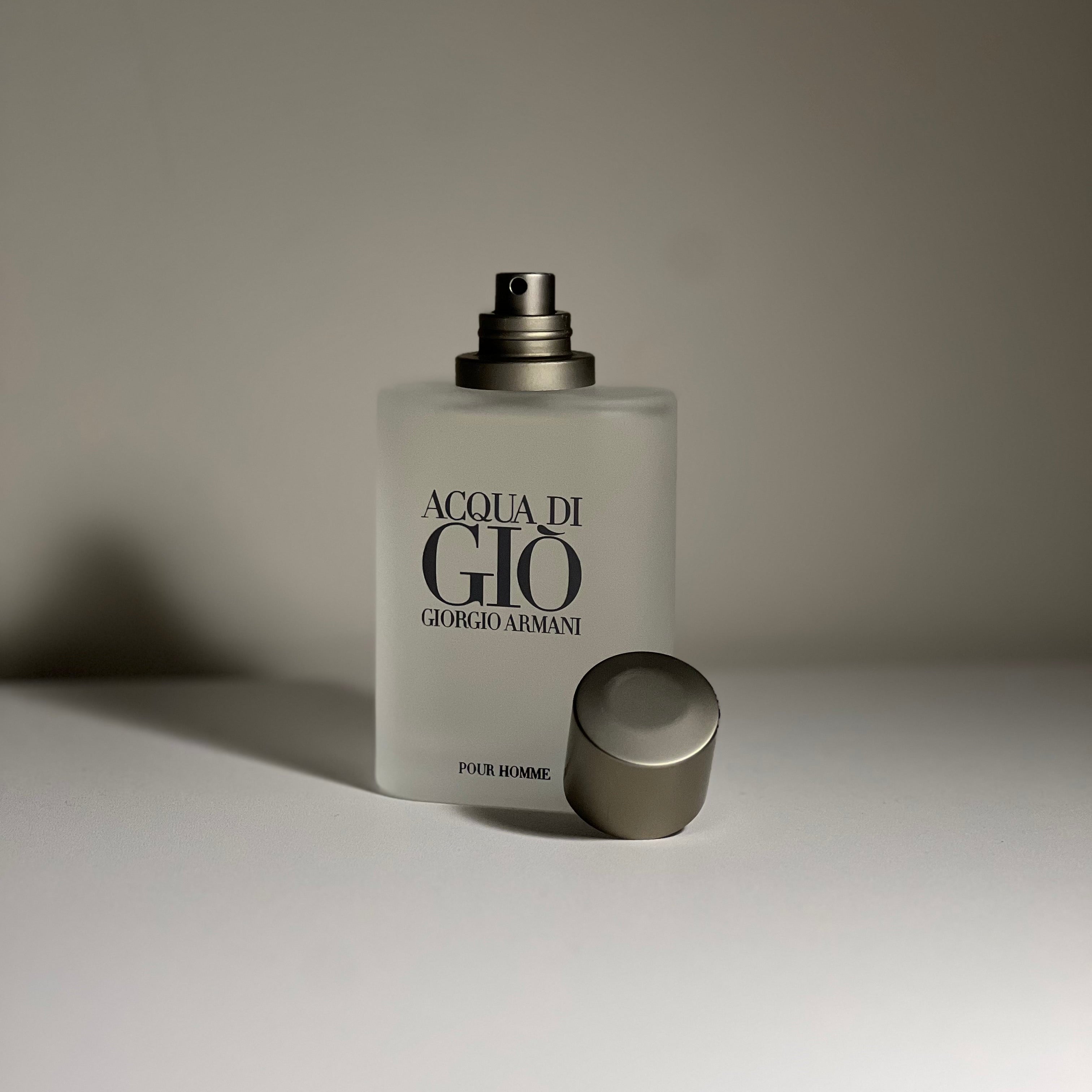 Perfume bottle labeled 'Acqua di Gio' by Giorgio Armani on a neutral background